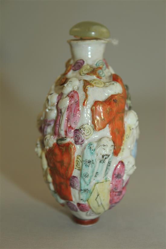 A Chinese moulded famille rose eighteen luohan snuff bottle, Qianlong seal mark, 1820-1850, 7.4cm